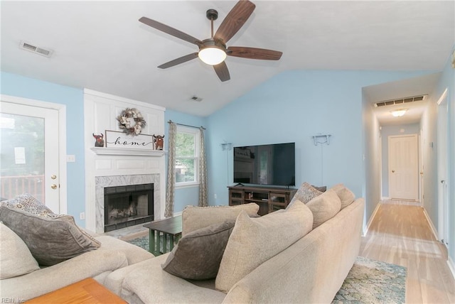 2405 Broadnax Cir, Chesapeake, VA 23323 - living area with vaulted ceiling, light wood finished floors, a ceiling fan, and a high end fireplace