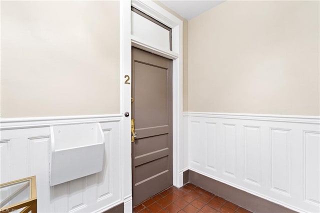 812 Stockley Gdns Unit 2, Norfolk, VA 23507 - entryway with wainscoting, dark tile patterned floors, and a decorative wall