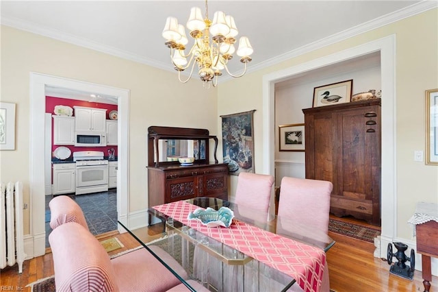 812 Stockley Gdns Unit 2, Norfolk, VA 23507 - dining room featuring radiator heating unit, a chandelier, wood finished floors, and crown molding