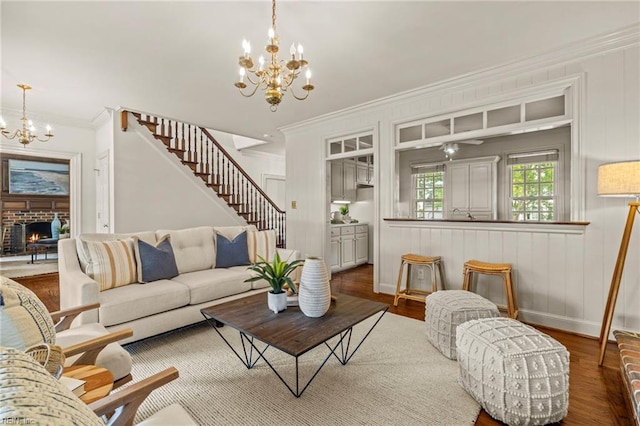 417 Peace Haven Dr, Norfolk, VA 23502 - living room with a chandelier, crown molding, stairs, wood finished floors, and a fireplace
