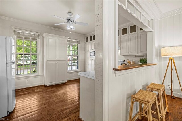 417 Peace Haven Dr, Norfolk, VA 23502 - kitchen featuring freestanding refrigerator, crown molding, dark wood-style floors, a ceiling fan, and white cabinetry