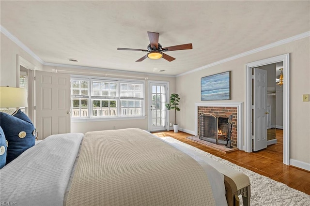 417 Peace Haven Dr, Norfolk, VA 23502 - bedroom with light wood finished floors, crown molding, a brick fireplace, ceiling fan, and access to outside