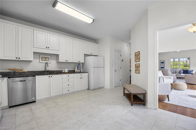 416 27th St, Virginia Beach, VA 23451 - kitchen featuring stainless steel dishwasher, freestanding refrigerator, white cabinets, and dark stone countertops