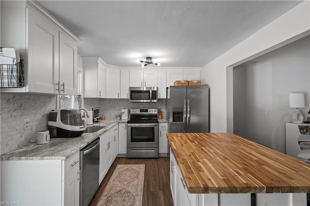1849 Head Of River Rd, Chesapeake, VA 23322 - kitchen featuring stainless steel appliances, butcher block countertops, dark wood-style floors, white cabinetry, and tasteful backsplash