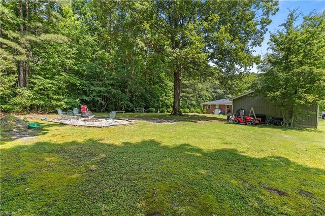1849 Head Of River Rd, Chesapeake, VA 23322 - view of green lawn featuring an outbuilding, a pole building, and a patio