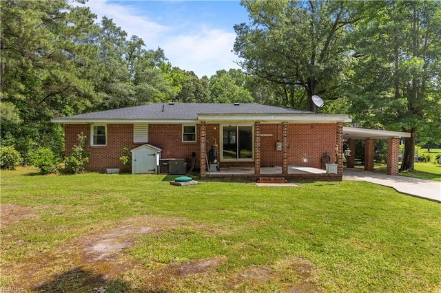 1849 Head Of River Rd, Chesapeake, VA 23322 - back of house featuring concrete driveway, a shed, a yard, and a carport