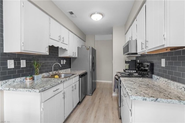 1601 Dominion Ct, Virginia Beach, VA 23453 - kitchen featuring stainless steel appliances, light wood-style floors, decorative backsplash, white cabinetry, and light stone countertops