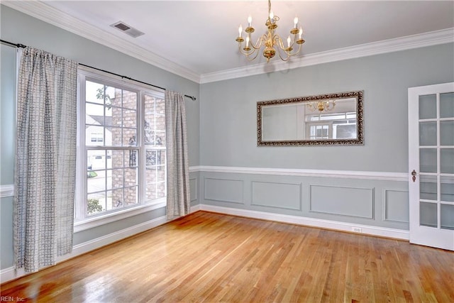 3248 Windsor Rdg, Williamsburg, VA 23188 - unfurnished dining area with a chandelier, wood finished floors, ornamental molding, healthy amount of natural light, and wainscoting