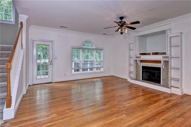 3248 Windsor Rdg, Williamsburg, VA 23188 - unfurnished living room with wood finished floors, stairway, ornamental molding, a ceiling fan, and a fireplace