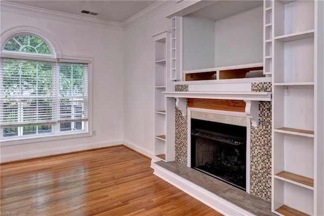 3248 Windsor Rdg, Williamsburg, VA 23188 - unfurnished living room with wood finished floors, crown molding, and a fireplace with raised hearth