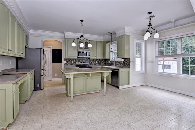 3248 Windsor Rdg, Williamsburg, VA 23188 - kitchen with green cabinets, stainless steel appliances, arched walkways, decorative backsplash, and a breakfast bar area