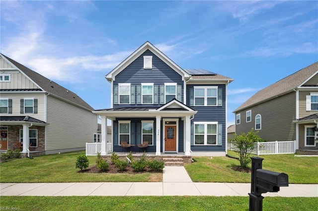958 Olmstead St, Chesapeake, VA 23323 - view of front facade with covered porch, roof mounted solar panels, and a standing seam roof