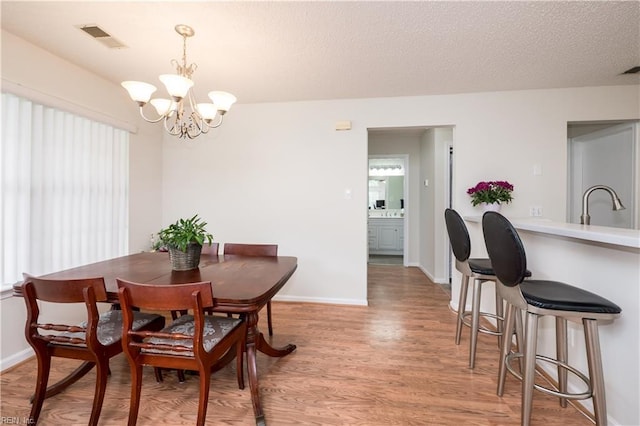 5088 Heathglen Cir, Virginia Beach, VA 23456 - dining space with a chandelier and light wood-type flooring