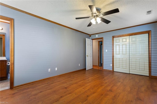 1121 Millay Ct, Virginia Beach, VA 23454 - unfurnished bedroom featuring wood finished floors, ensuite bathroom, a ceiling fan, crown molding, and a textured ceiling