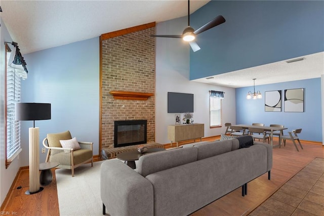 1121 Millay Ct, Virginia Beach, VA 23454 - living room with wood finished floors, a chandelier, a brick fireplace, ceiling fan, and high vaulted ceiling