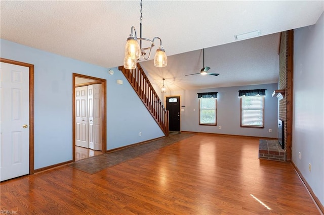 1121 Millay Ct, Virginia Beach, VA 23454 - unfurnished living room featuring stairway, wood finished floors, ceiling fan, a fireplace, and a textured ceiling