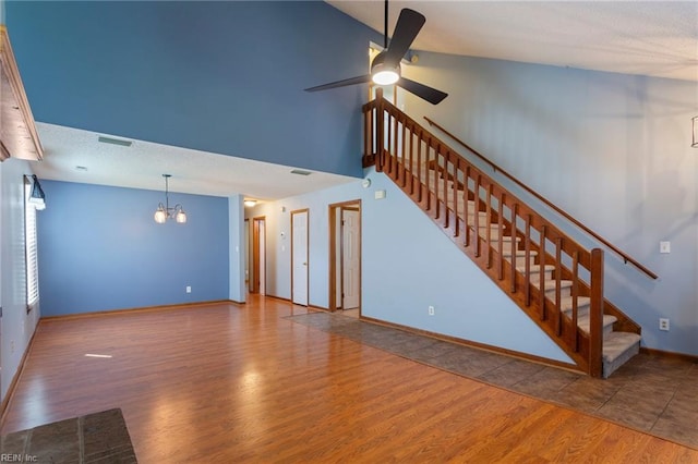 1121 Millay Ct, Virginia Beach, VA 23454 - unfurnished living room with a chandelier, wood finished floors, a ceiling fan, stairs, and high vaulted ceiling