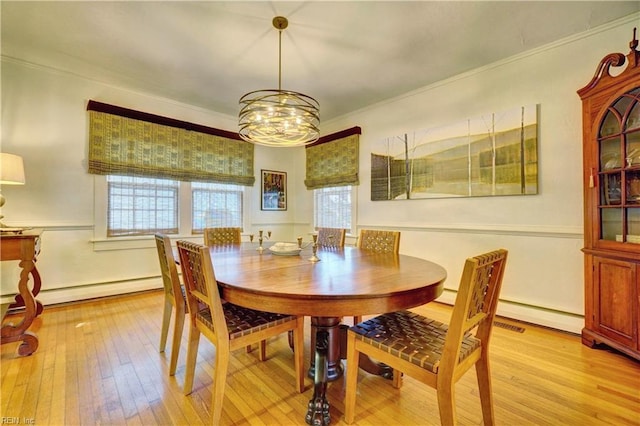 1357 Buckingham Ave, Norfolk, VA 23508 - dining room featuring a baseboard heating unit, ornamental molding, light wood-style floors, and a chandelier