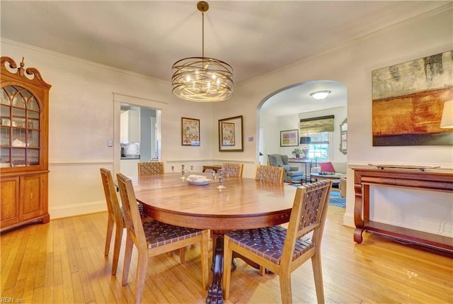 1357 Buckingham Ave, Norfolk, VA 23508 - dining area featuring arched walkways, light wood-style floors, ornamental molding, and a chandelier