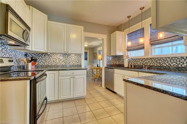 1357 Buckingham Ave, Norfolk, VA 23508 - kitchen with appliances with stainless steel finishes, decorative backsplash, light tile patterned floors, and white cabinetry