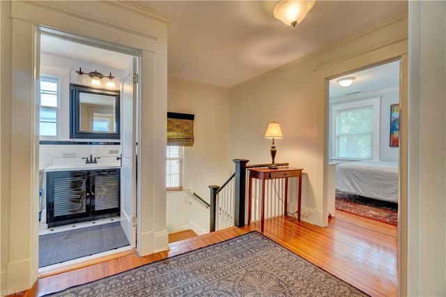 1357 Buckingham Ave, Norfolk, VA 23508 - corridor with wood finished floors, an upstairs landing, and crown molding