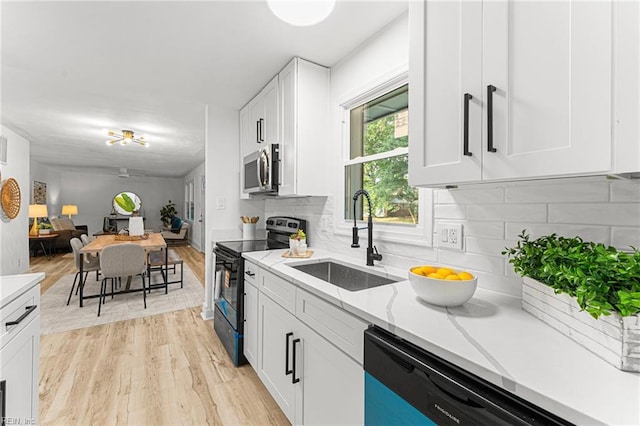459 Dauphin Ln, Virginia Beach, VA 23452 - kitchen featuring black electric range, dishwasher, stainless steel microwave, light wood-type flooring, and white cabinets