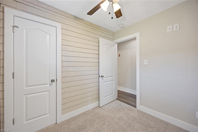 3332 Lusk St, Virginia Beach, VA 23464 - unfurnished bedroom with carpet, wood walls, and a ceiling fan