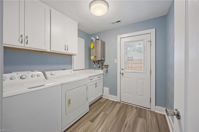 3332 Lusk St, Virginia Beach, VA 23464 - laundry room featuring tankless water heater, cabinet space, washing machine and dryer, and light wood finished floors