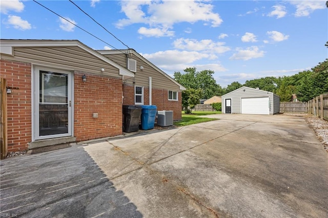 3332 Lusk St, Virginia Beach, VA 23464 - view of home's exterior with a garage, brick siding, an outbuilding, and concrete driveway