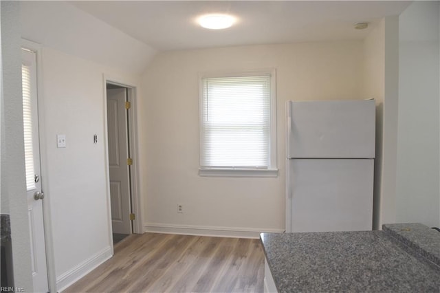 1910 N Lakeland Dr, Norfolk, VA 23518 - kitchen with freestanding refrigerator, light wood-type flooring, and dark stone countertops