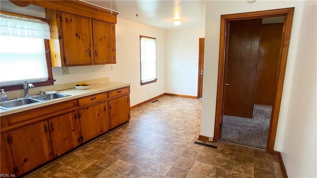 1220 E Balview Ave, Norfolk, VA 23503 - kitchen with plenty of natural light, light countertops, and brown cabinets