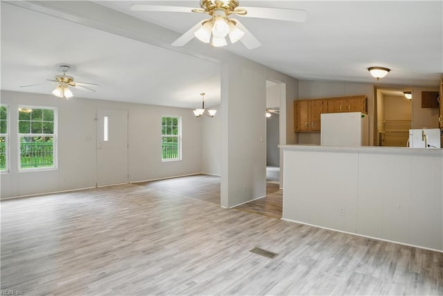 349 Pepper Cove Way, Susan, VA 23163 - unfurnished living room with ceiling fan, light wood-style floors, a chandelier, and lofted ceiling