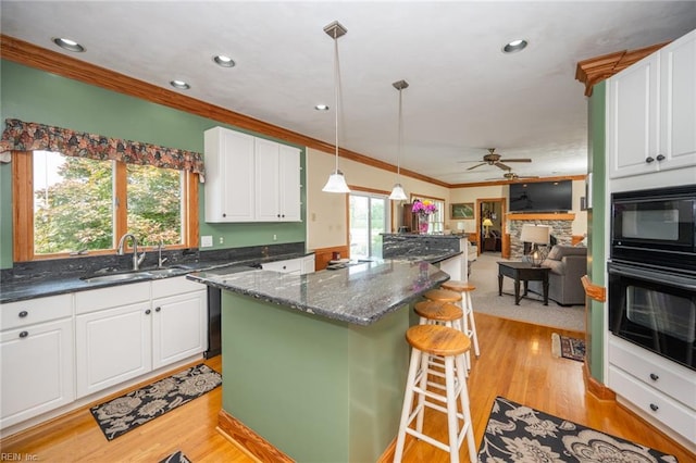 1040 Sanderson Rd, Chesapeake, VA 23322 - kitchen featuring black appliances, crown molding, white cabinets, a kitchen island, and a ceiling fan