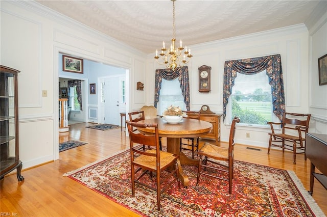 1040 Sanderson Rd, Chesapeake, VA 23322 - dining space featuring a decorative wall, ornamental molding, a chandelier, and light wood finished floors