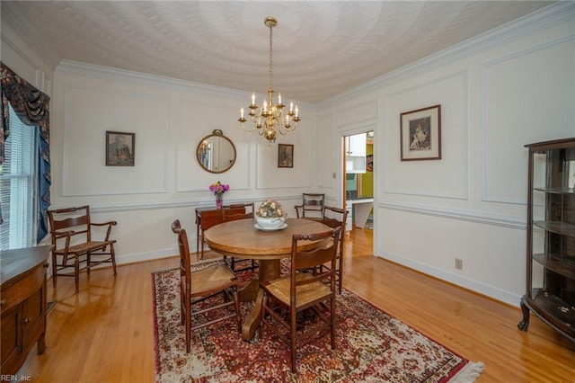 1040 Sanderson Rd, Chesapeake, VA 23322 - dining room with a decorative wall, crown molding, a chandelier, and light wood-type flooring