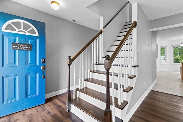 114 Lancelot Dr, Suffolk, VA 23434 - foyer entrance with wood finished floors, stairway, and a textured ceiling