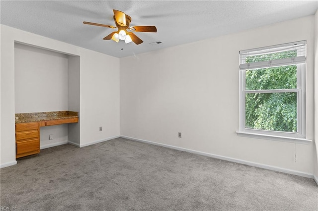 114 Lancelot Dr, Suffolk, VA 23434 - unfurnished room featuring ceiling fan, carpet, built in desk, and a textured ceiling