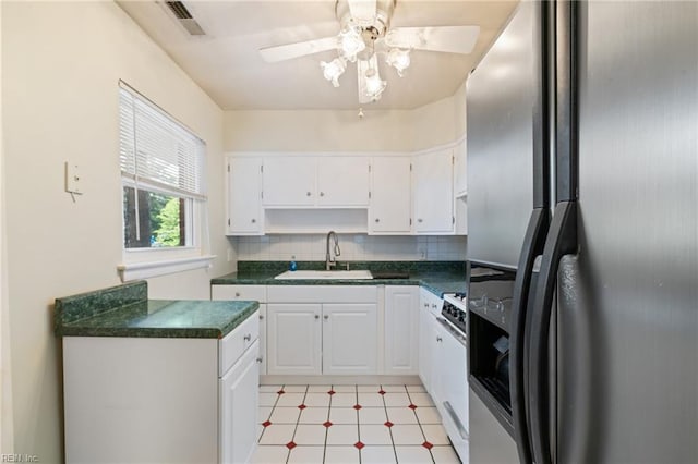 5813 Andrea Dr, Norfolk, VA 23518 - kitchen featuring stainless steel fridge with ice dispenser, gas stove, dark countertops, white cabinetry, and tasteful backsplash