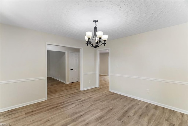 2001 Blackwell Ct, Virginia Beach, VA 23464 - unfurnished room with a chandelier, light wood finished floors, and a textured ceiling