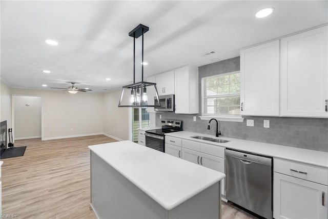 2001 Blackwell Ct, Virginia Beach, VA 23464 - kitchen with stainless steel appliances, recessed lighting, light countertops, decorative backsplash, and white cabinetry