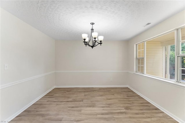 2001 Blackwell Ct, Virginia Beach, VA 23464 - spare room with a chandelier, wood finished floors, and a textured ceiling