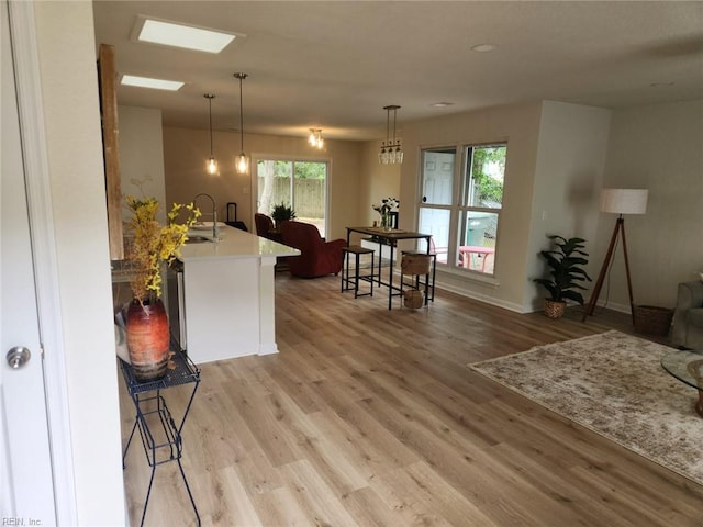 13031 Green Grove Ln, Newport News, VA 23608 - kitchen featuring light wood finished floors, plenty of natural light, and decorative light fixtures