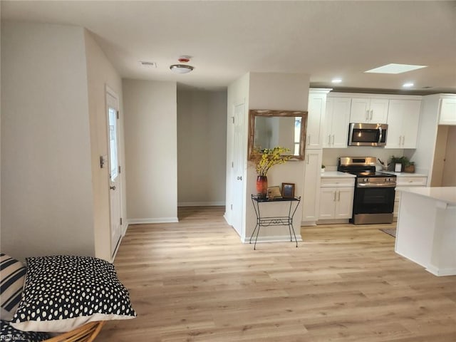 13031 Green Grove Ln, Newport News, VA 23608 - kitchen with appliances with stainless steel finishes, white cabinetry, light countertops, light wood finished floors, and recessed lighting