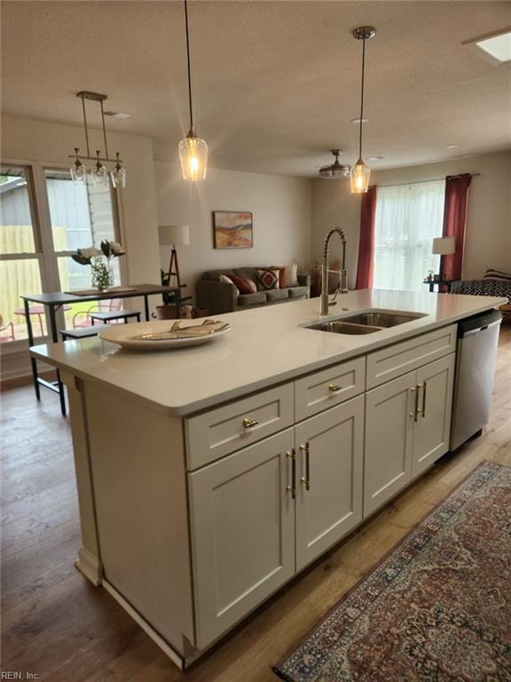13031 Green Grove Ln, Newport News, VA 23608 - kitchen featuring dishwasher, hanging light fixtures, a kitchen island with sink, open floor plan, and a textured ceiling
