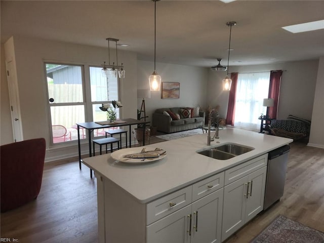 13031 Green Grove Ln, Newport News, VA 23608 - kitchen with stainless steel dishwasher, open floor plan, wood finished floors, a center island with sink, and light countertops