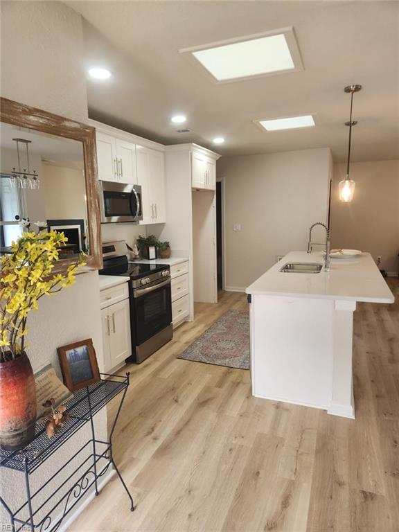 13031 Green Grove Ln, Newport News, VA 23608 - kitchen featuring appliances with stainless steel finishes, white cabinetry, light countertops, light wood-style floors, and recessed lighting