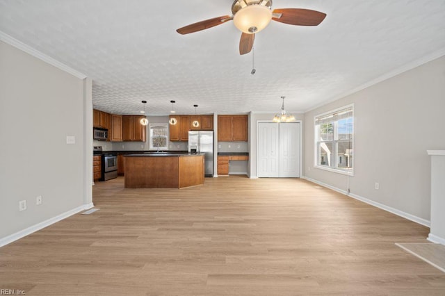 5561 Taylors Walke Ln, Virginia Beach, VA 23462 - kitchen featuring stainless steel appliances, dark countertops, ornamental molding, brown cabinetry, and open floor plan