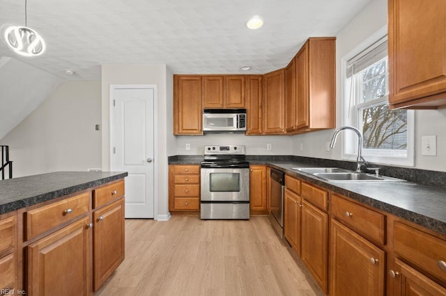 5561 Taylors Walke Ln, Virginia Beach, VA 23462 - kitchen featuring stainless steel appliances, light wood-style floors, dark countertops, brown cabinetry, and recessed lighting