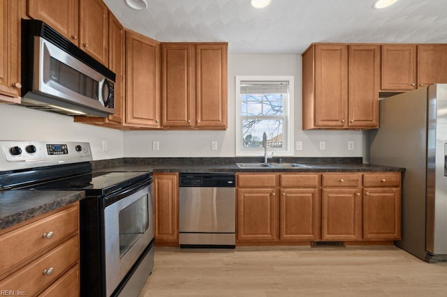 5561 Taylors Walke Ln, Virginia Beach, VA 23462 - kitchen featuring appliances with stainless steel finishes, dark countertops, brown cabinets, and recessed lighting