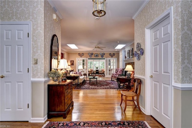 8265 Wrenfield Dr, Williamsburg, VA 23188 - foyer featuring wallpapered walls, wood finished floors, crown molding, ceiling fan, and wainscoting